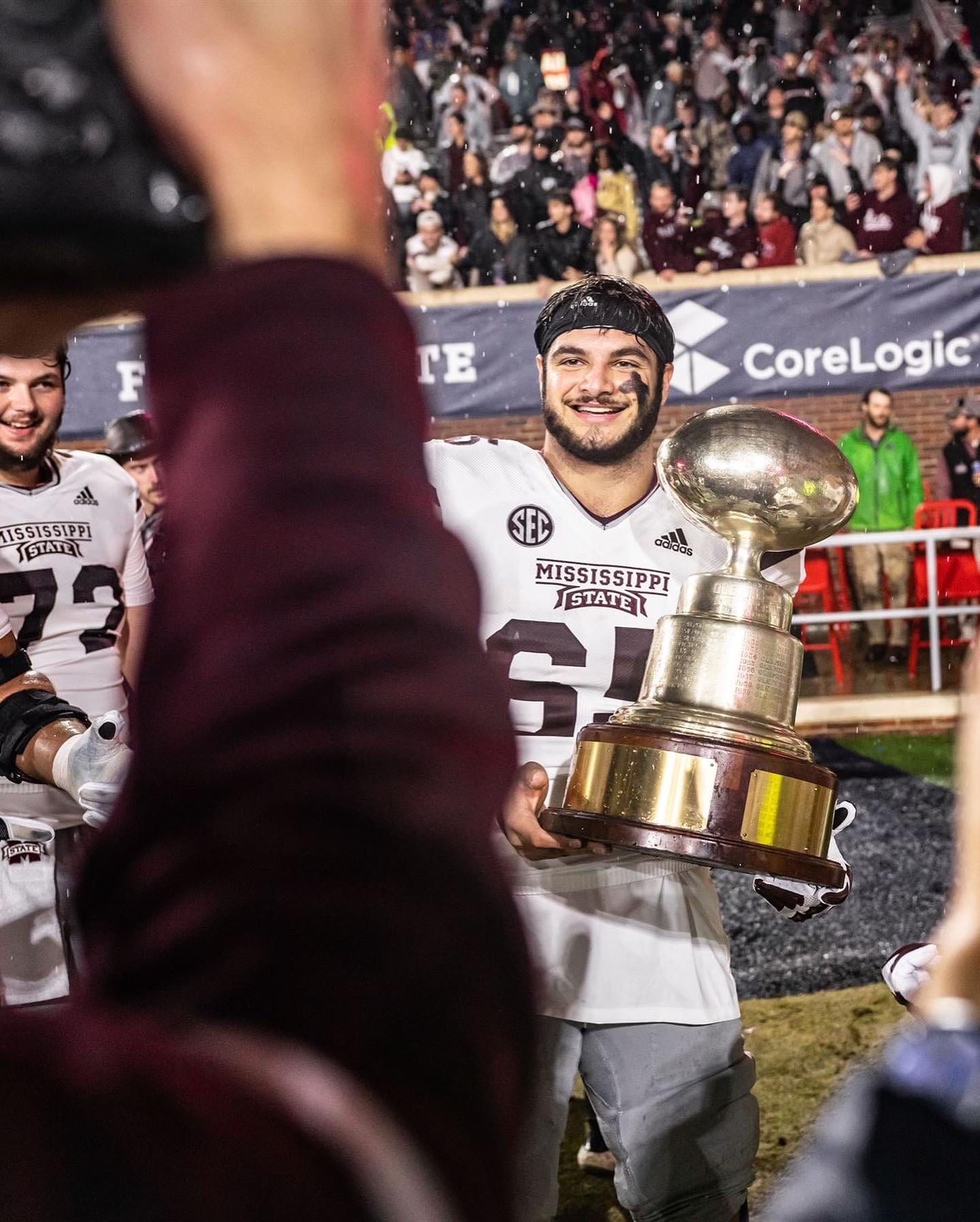 Jon-Thomas Zakkak (#65) with the Egg Bowl Golden Egg trophy at Mississippi State